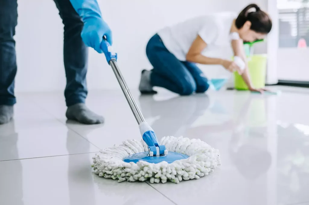 Cleaners mopping and scrubbing floors during Airbnb turnover cleaning in Perth by NewTouch Cleaning
